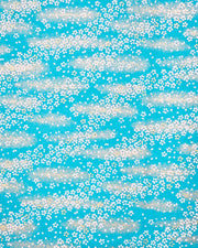 Japanese chiyogami paper featuring small white and gold cherry blossoms on a turquoise blue background with metallic gold details.