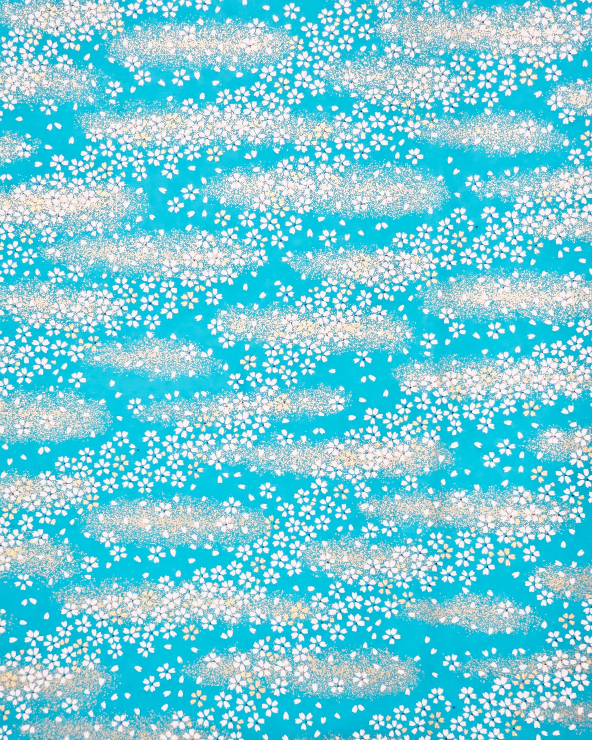 Japanese chiyogami paper featuring small white and gold cherry blossoms on a turquoise blue background with metallic gold details.