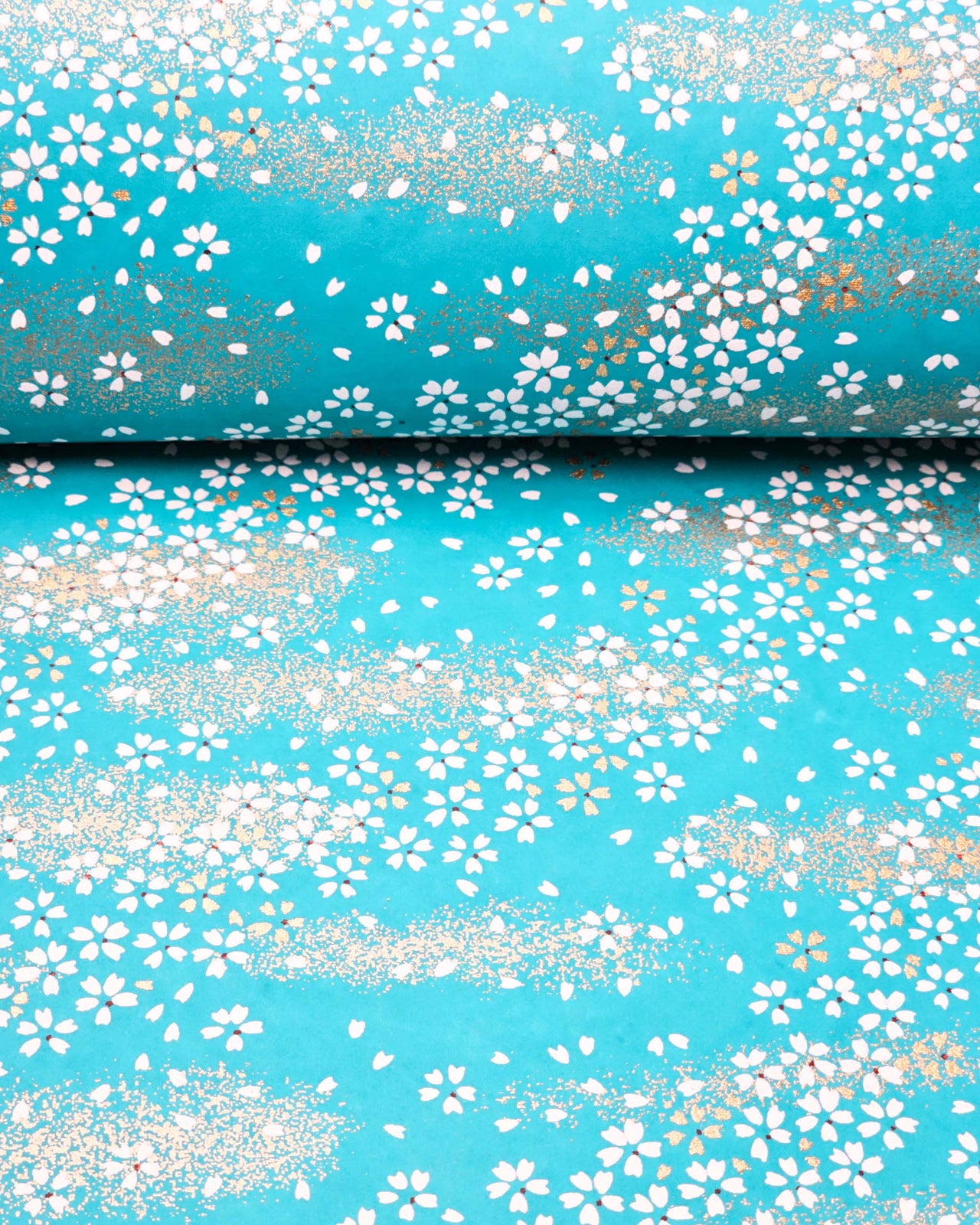 Japanese chiyogami paper featuring small white and gold cherry blossoms on a turquoise blue background with metallic gold details.