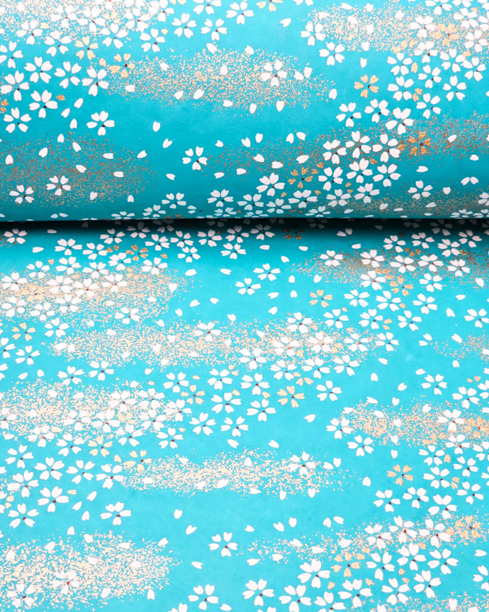 Japanese chiyogami paper featuring small white and gold cherry blossoms on a turquoise blue background with metallic gold details.