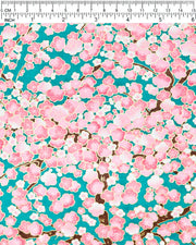 Japanese chiyogami paper featuring pink and white plum blossom trees with brown branches on a teal green background with metallic gold details.