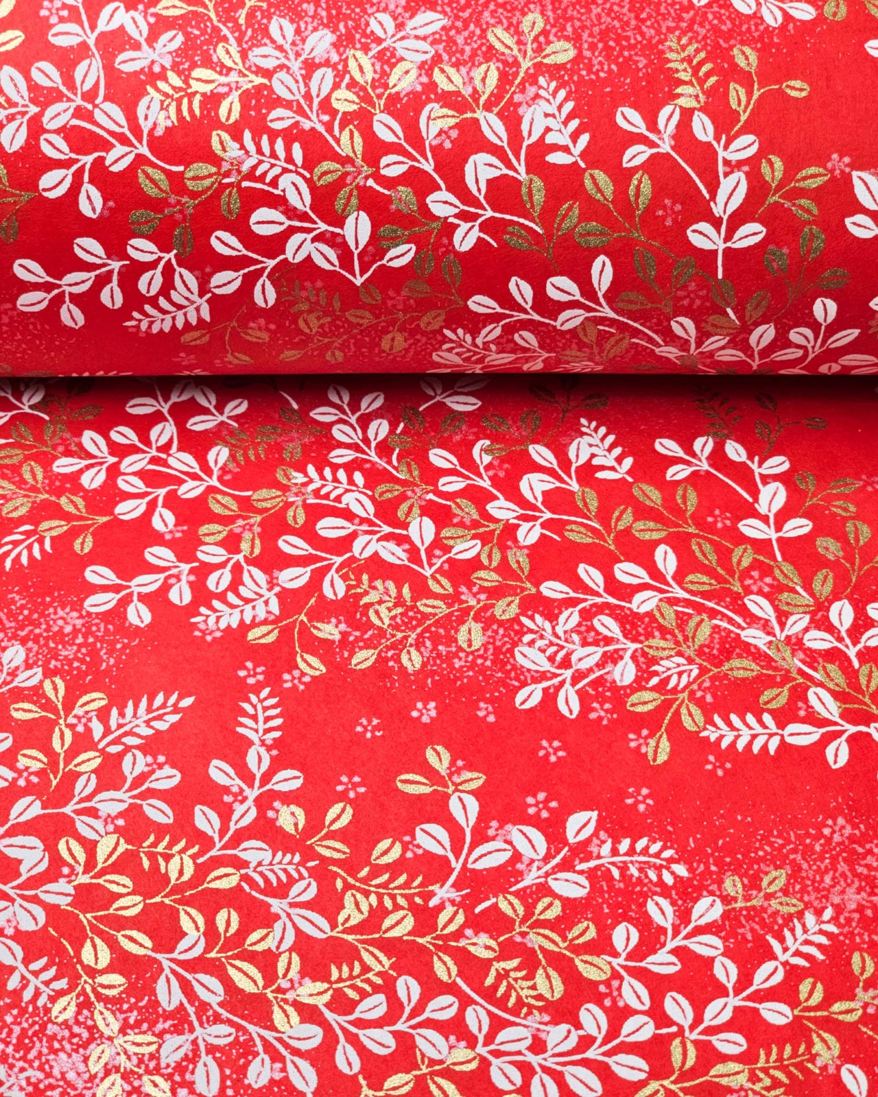 Japanese chiyogami paper featuring metallic gold and white hagi (bush clover) on a red background.