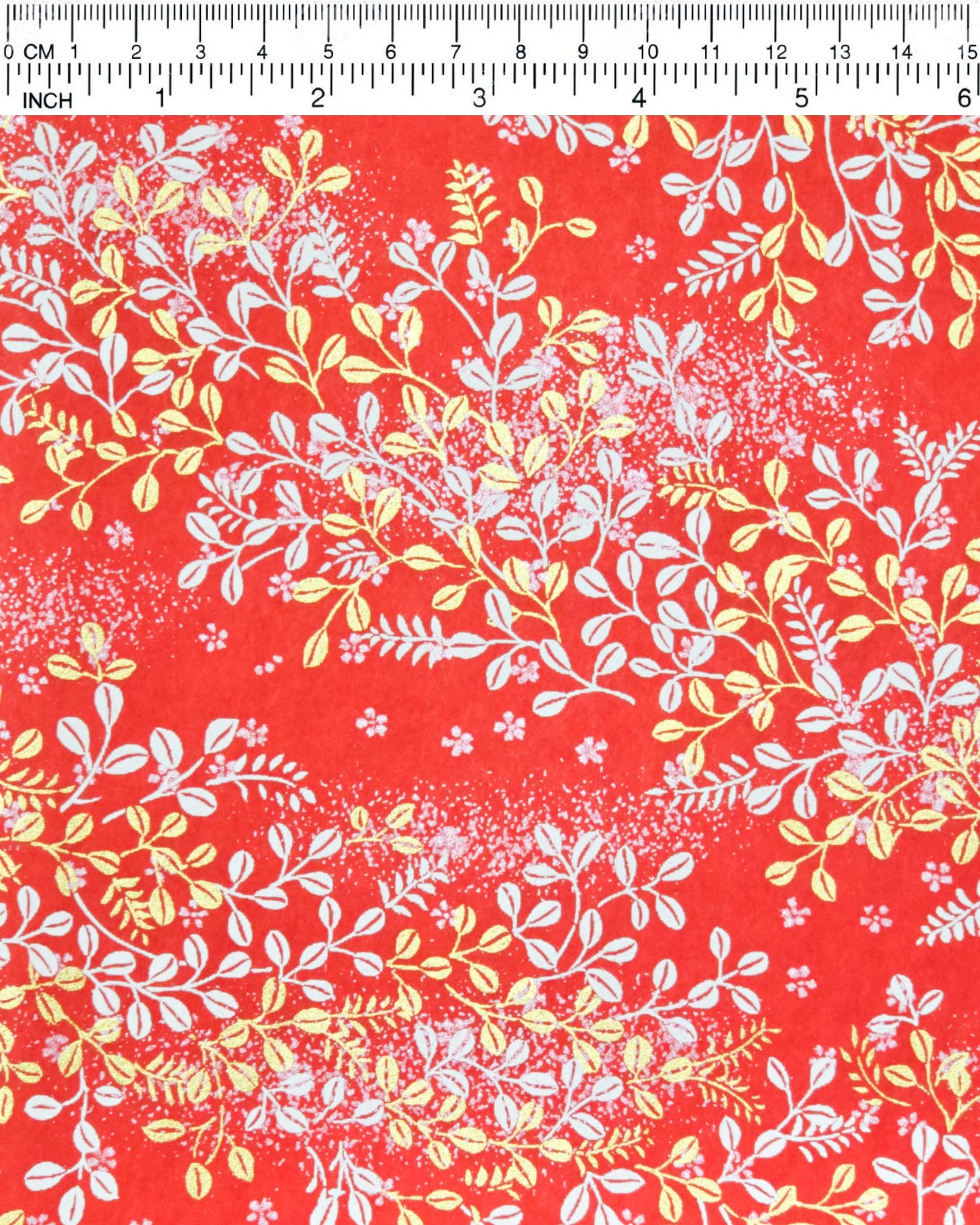 Japanese chiyogami paper featuring metallic gold and white hagi (bush clover) on a red background.