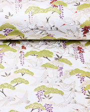 Japanese chiyogami paper featuring white flying cranes, purple and red wisteria, and green pine on a pearlescent white background with metallic gold details.