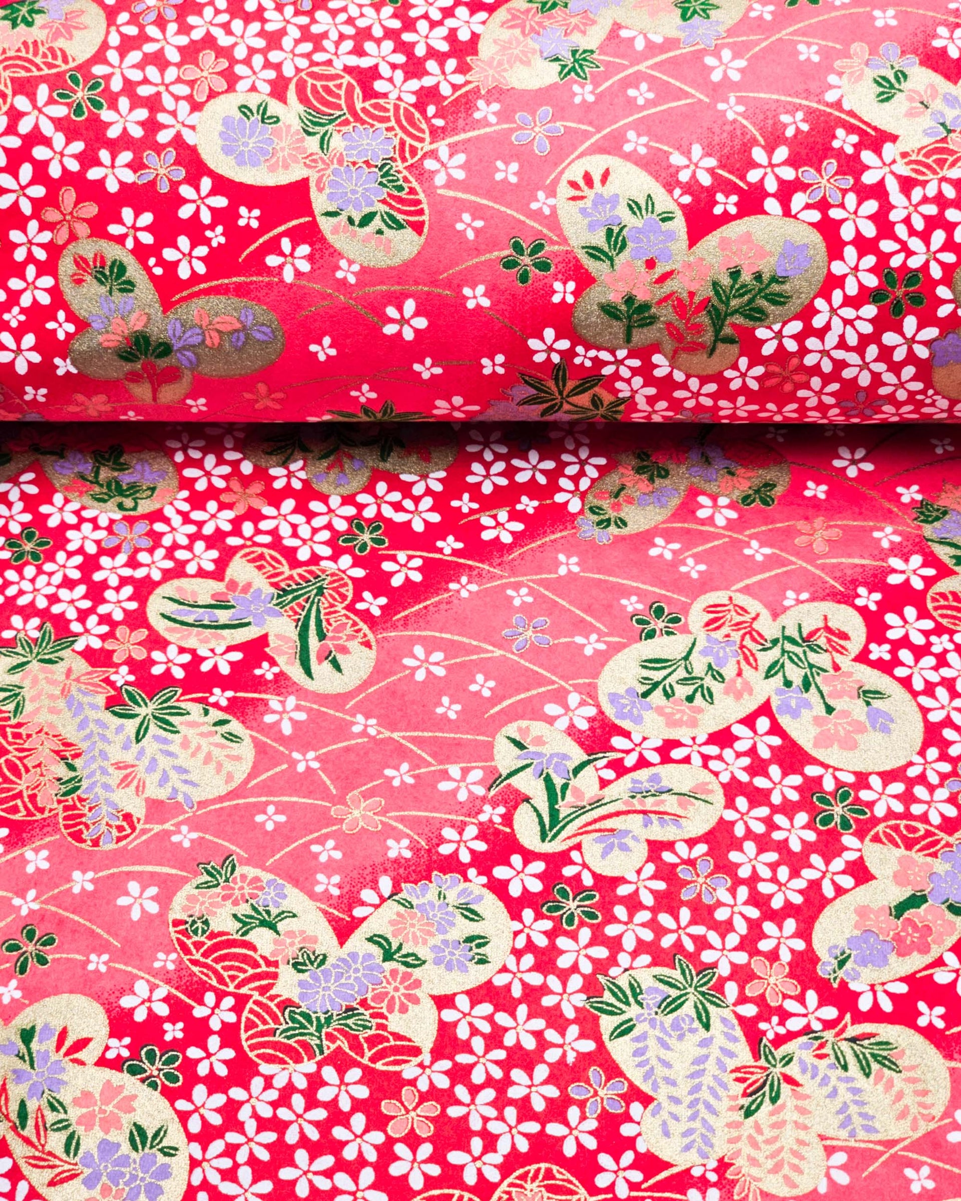 Japanese chiyogami paper featuring metallic gold butterflies with purple and pink flowers on a red background covered with small white flowers.