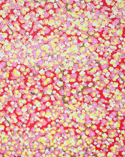 Japanese chiyogami paper featuring pink, yellow, and white plum blossom trees with brown branches on a red background with metallic gold details.