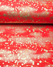 Japanese chiyogami paper featuring scattered metallic gold geometric shapes and fine gold lines on a red background.