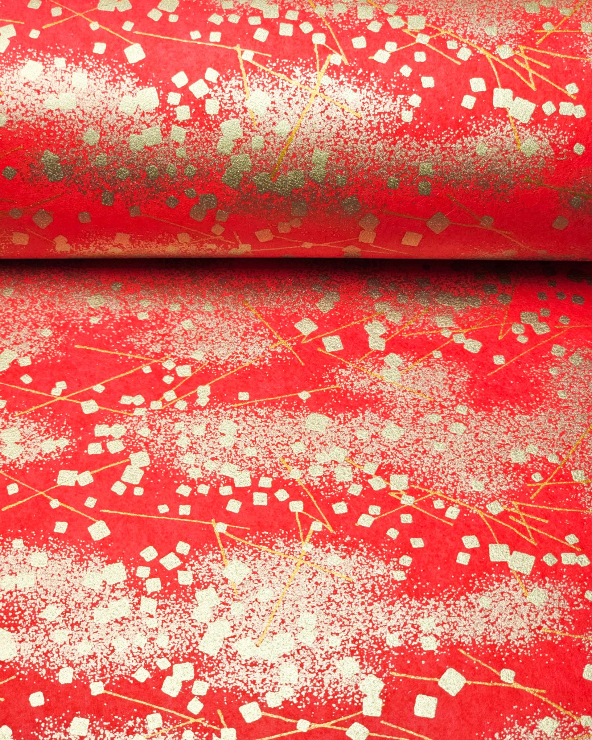 Japanese chiyogami paper featuring scattered metallic gold geometric shapes and fine gold lines on a red background.