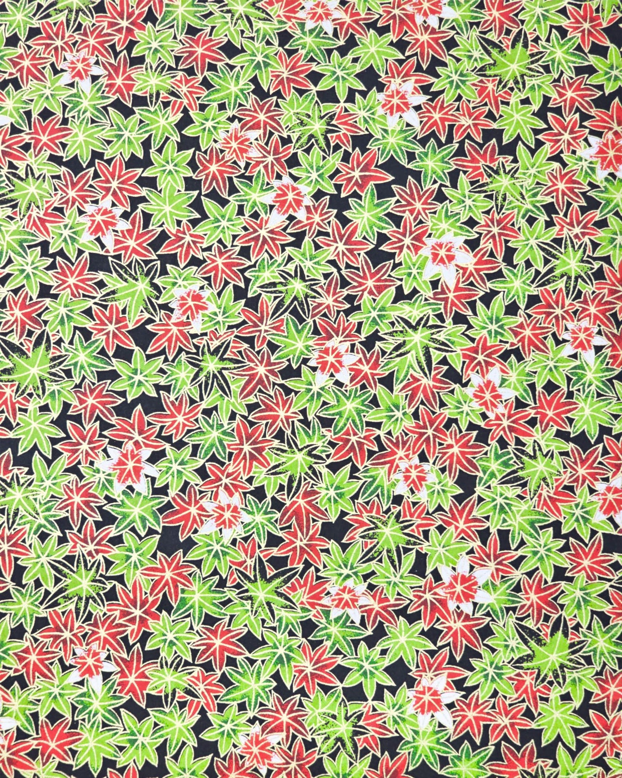 Japanese chiyogami paper featuring red, green, and white maples leaves on a black background with metallic gold details.