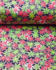 Japanese chiyogami paper featuring red, green, and white maples leaves on a black background with metallic gold details.