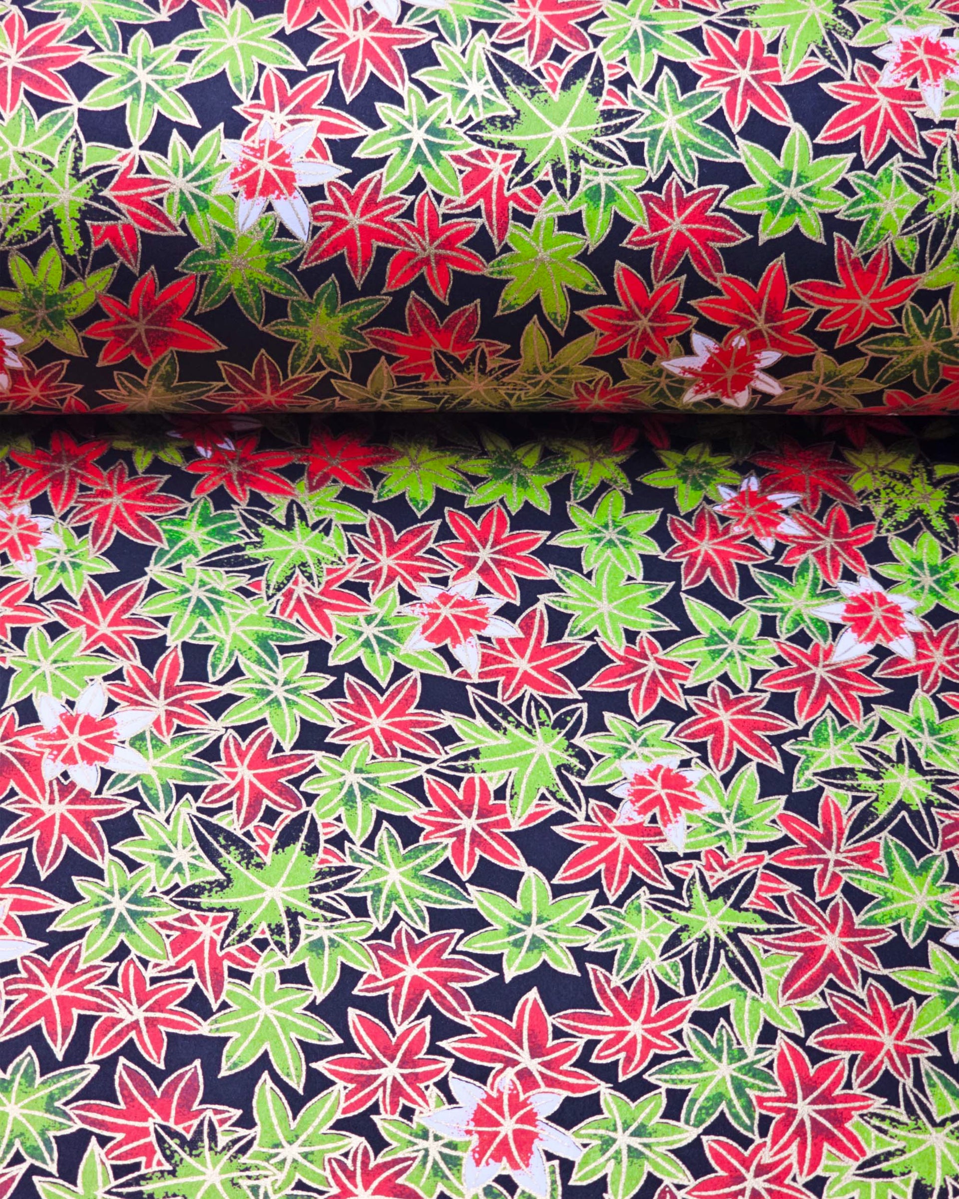 Japanese chiyogami paper featuring red, green, and white maples leaves on a black background with metallic gold details.