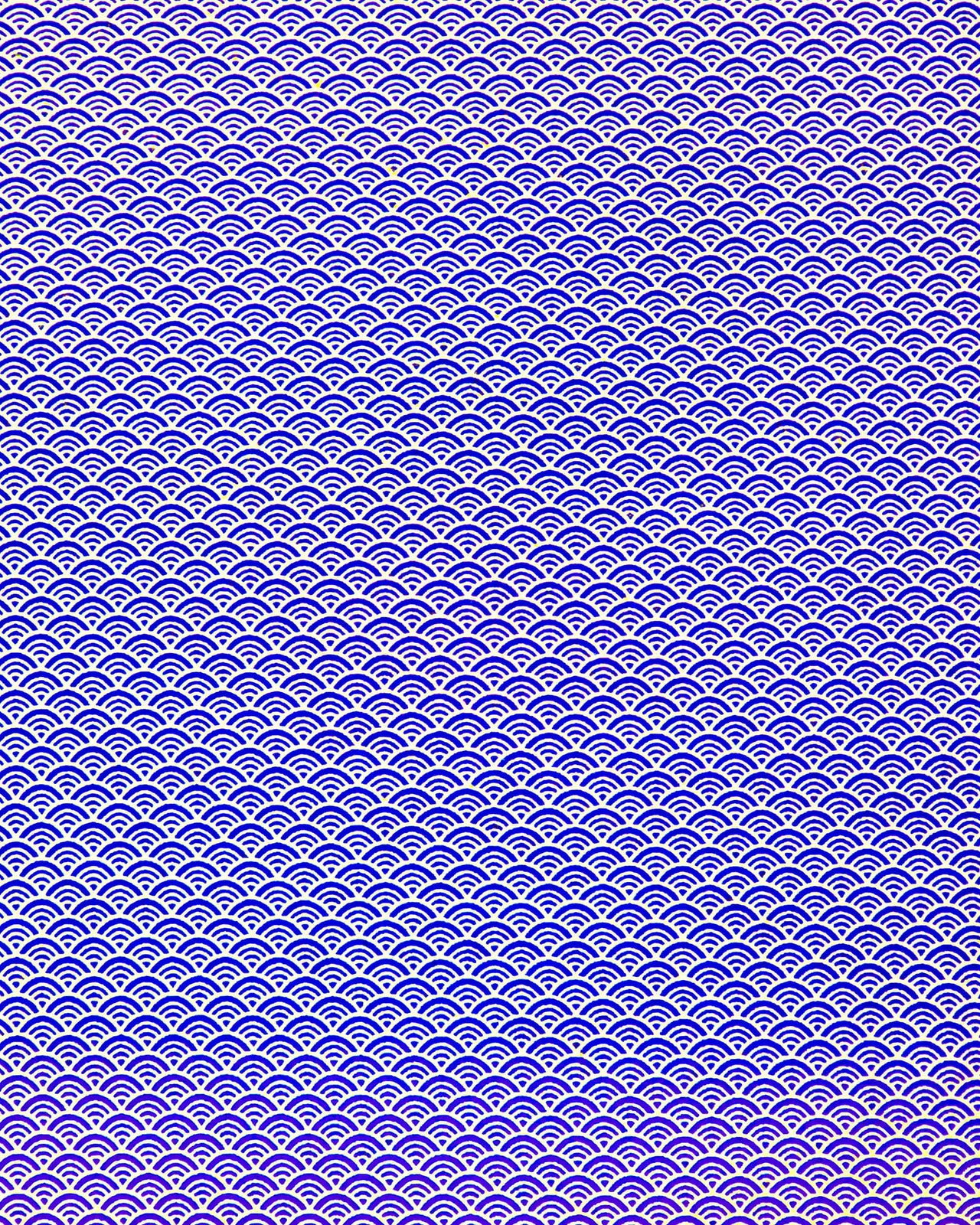 Japanese chiyogami paper featuring a small traditional blue and metallic gold seigaiha (wave crests) pattern.