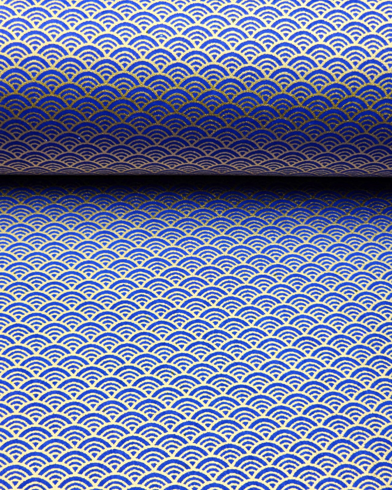 Japanese chiyogami paper featuring a small traditional blue and metallic gold seigaiha (wave crests) pattern.