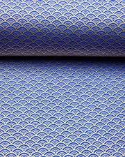 Japanese chiyogami paper featuring a small metallic gold seigaiha wave crest design on a blue background.