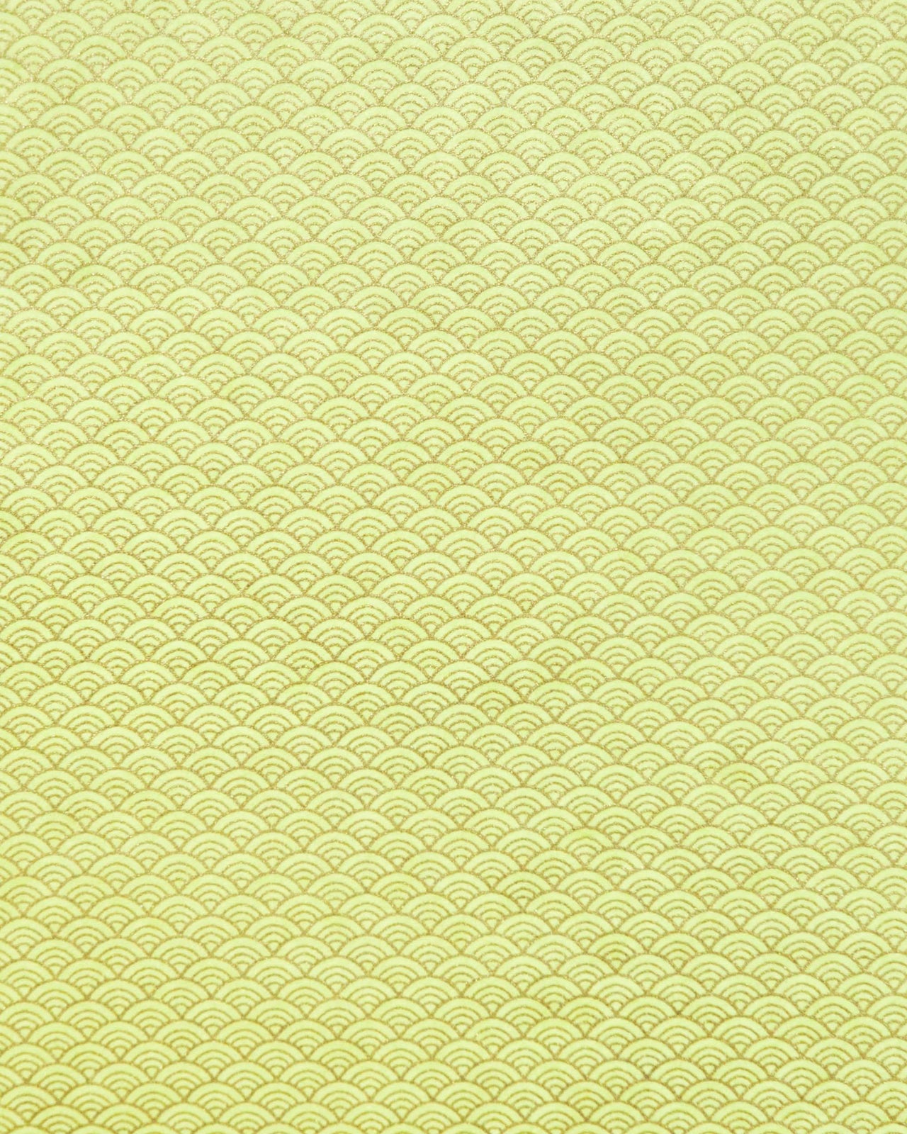 Japanese chiyogami paper featuring a small metallic gold seigaiha wave crest design on a yellow background.