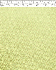 Japanese chiyogami paper featuring a small metallic gold seigaiha wave crest design on a yellow background.