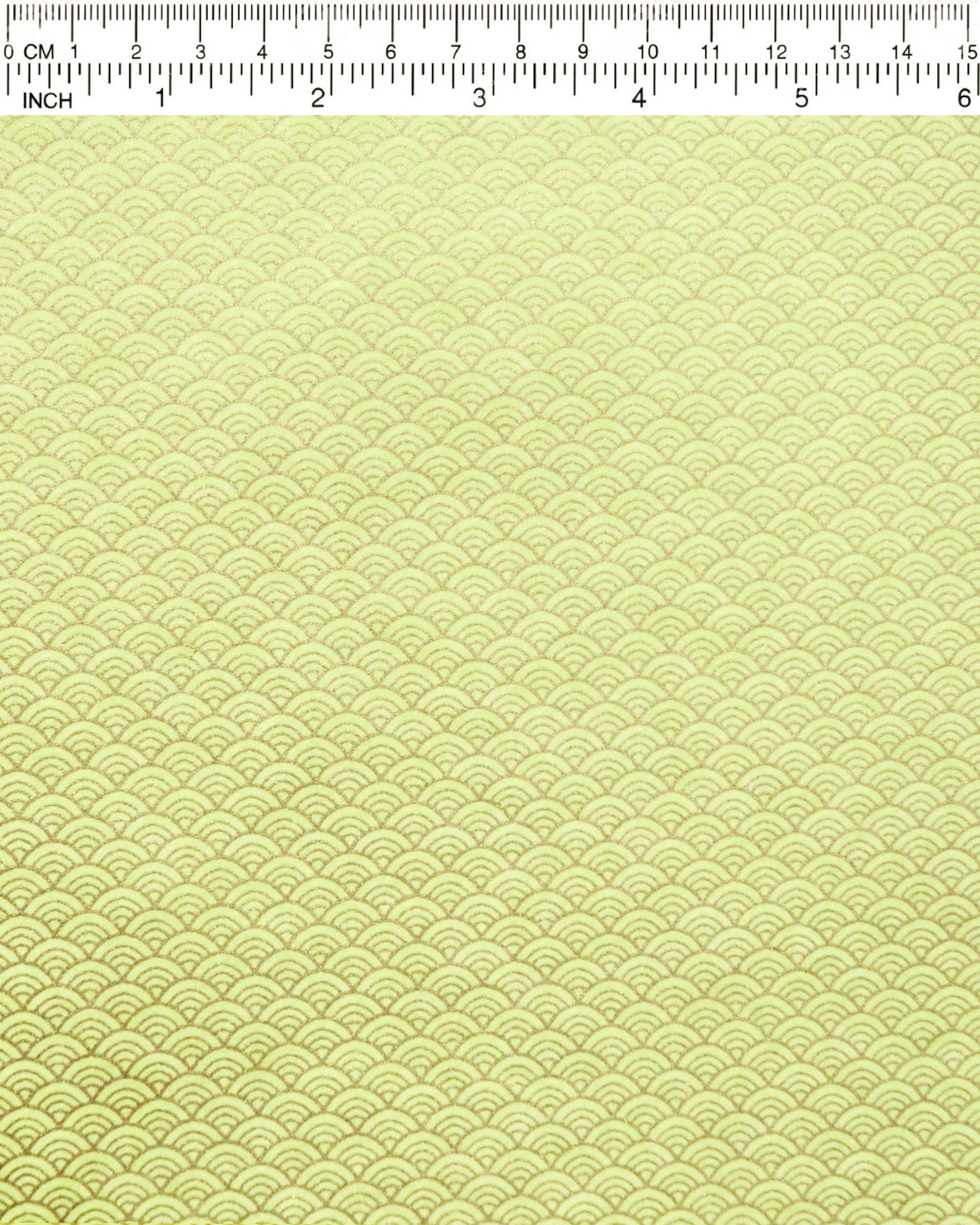 Japanese chiyogami paper featuring a small metallic gold seigaiha wave crest design on a yellow background.