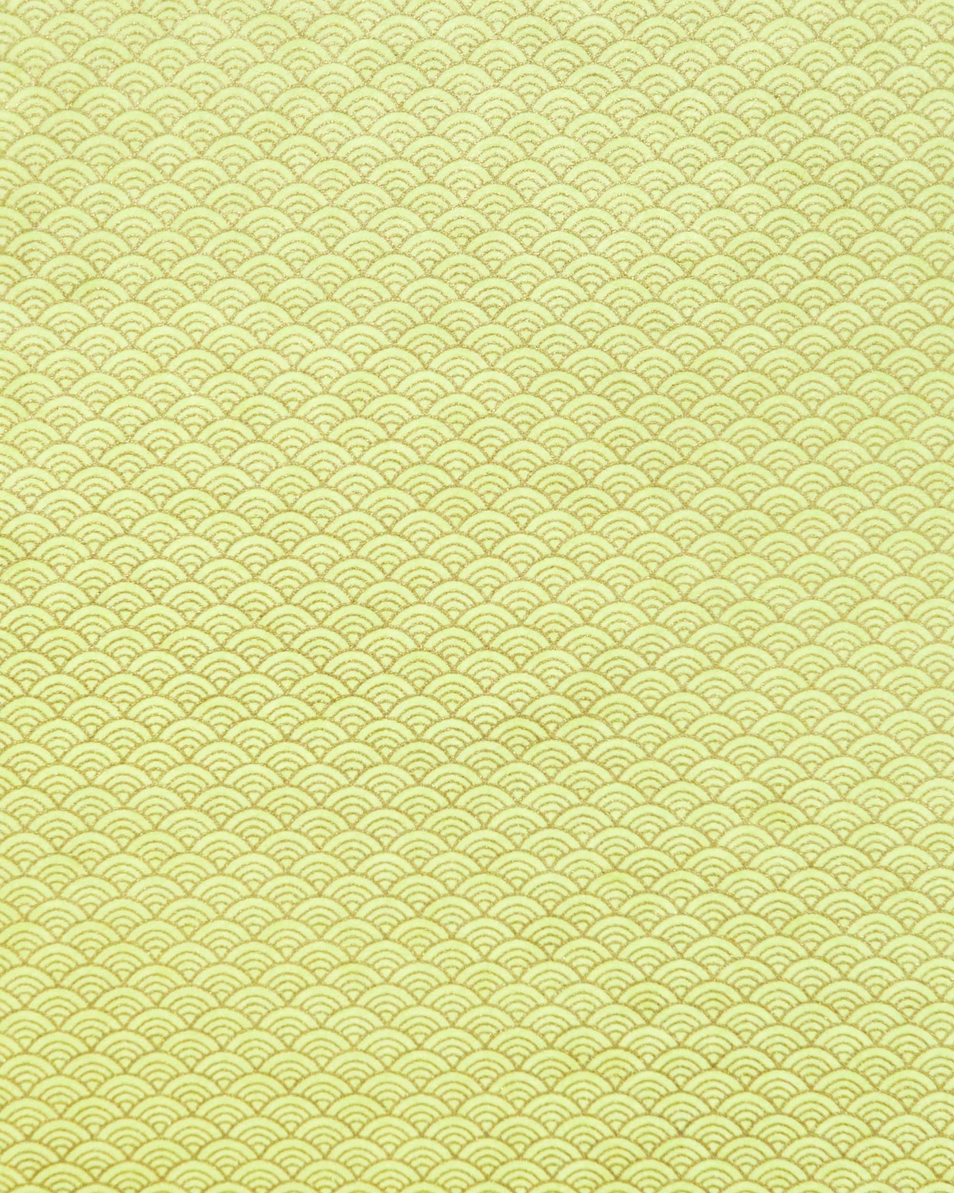 Japanese chiyogami paper featuring a small traditional yellow and metallic gold seigaiha (wave crests) pattern.