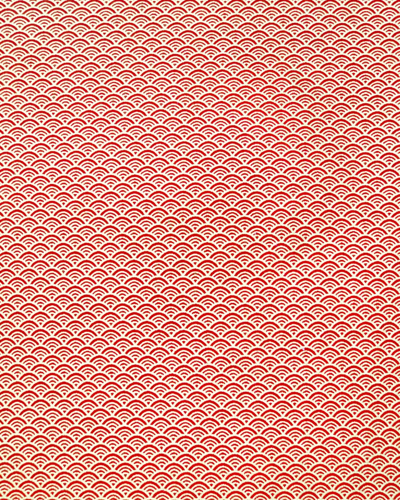 Japanese chiyogami paper featuring a small metallic gold seigaiha wave crest design on a red background.