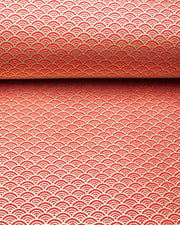 Japanese chiyogami paper featuring a small metallic gold seigaiha wave crest design on a red background.