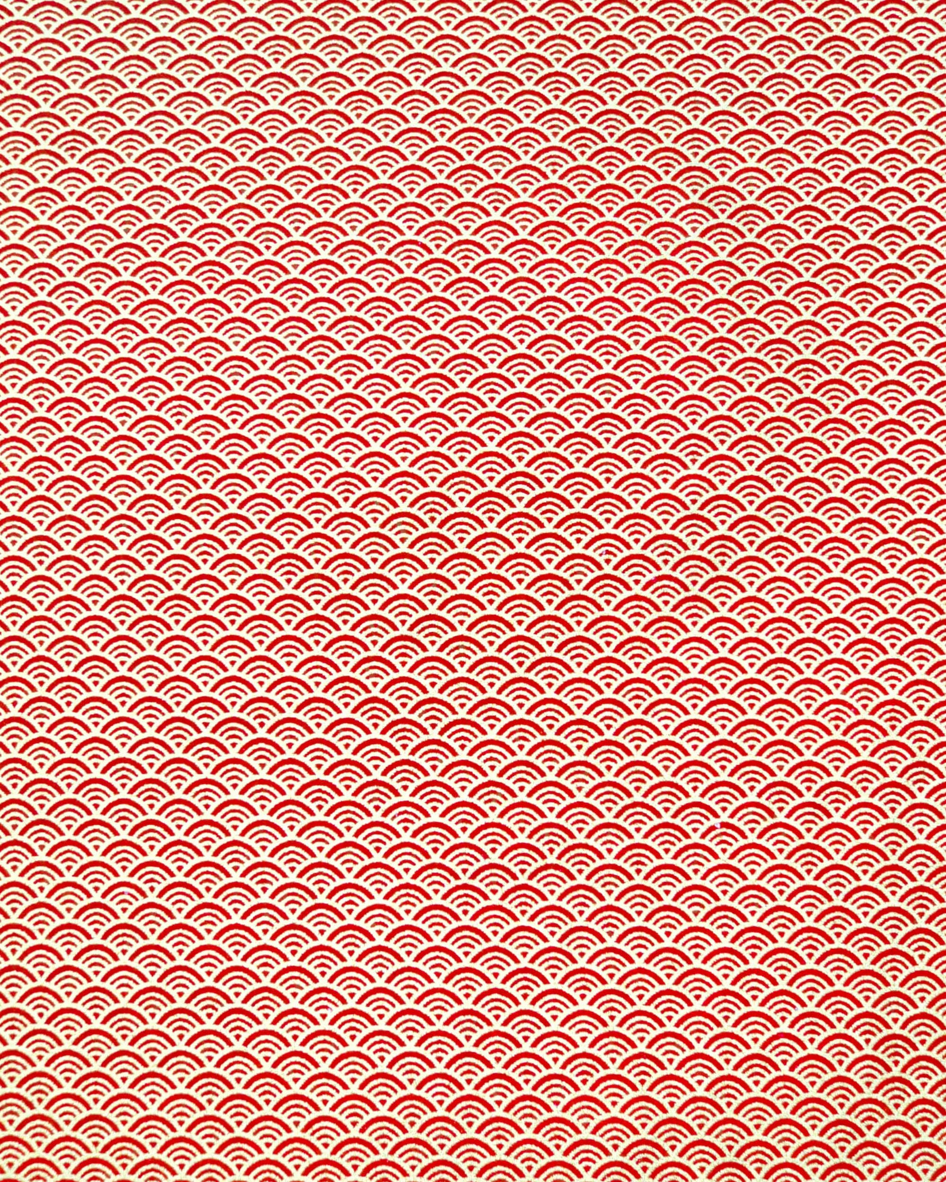 Japanese chiyogami paper featuring a small traditional red and metallic gold seigaiha (wave crests) pattern.
