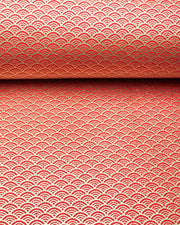 Japanese chiyogami paper featuring a small traditional red and metallic gold seigaiha (wave crests) pattern.