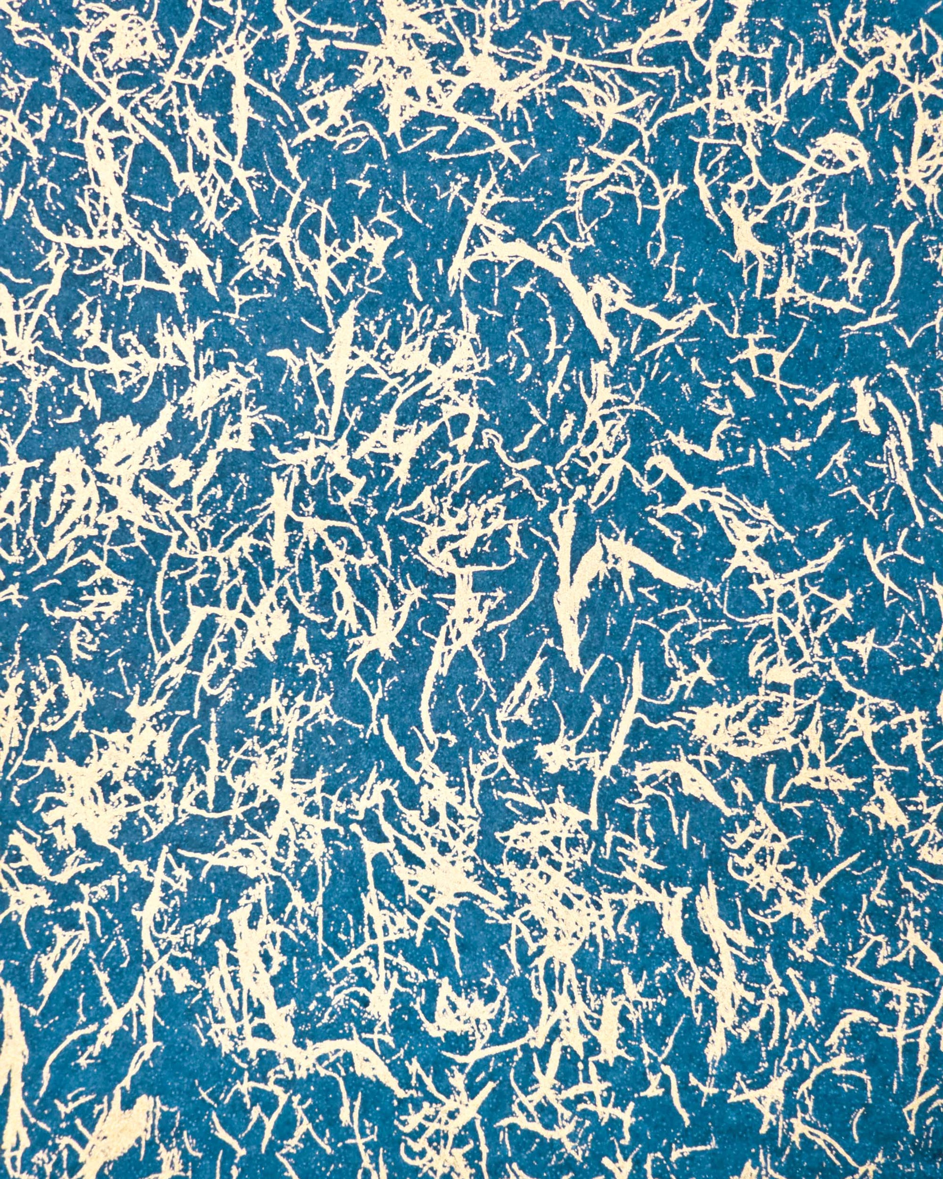 Japanese chiyogami paper featuring a metallic gold fiber-like unryu design on a blue background.