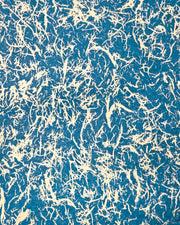 Japanese chiyogami paper featuring metallic gold fibers in the style of traditional unryu paper on a dark blue background.