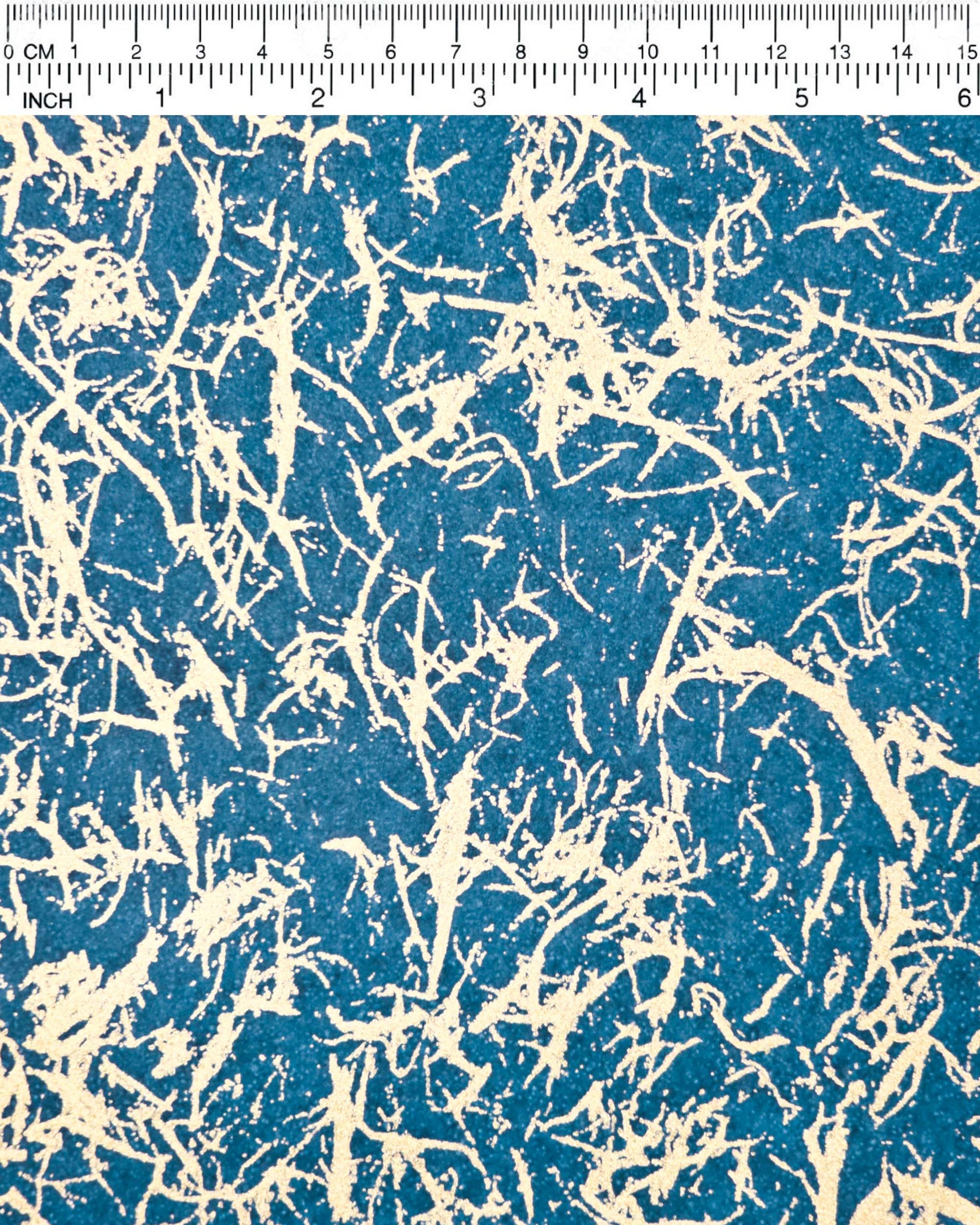 Japanese chiyogami paper featuring a metallic gold fiber-like unryu design on a blue background.