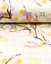 Japanese chiyogami paper featuring purple and orange plum blossoms with black branches set on top of a metallic silver hishi design on a cream background with metallic gold details.