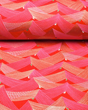 Japanese chiyogami paper featuring thin metallic gold and white lines in a triangular shape with small green and white triangles on a red background.