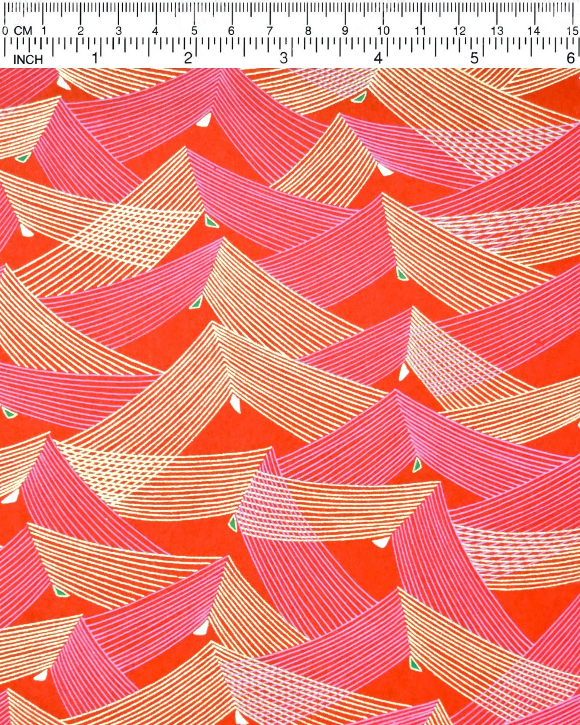 Japanese chiyogami paper featuring thin metallic gold and white lines in a triangular shape with small green and white triangles on a red background.