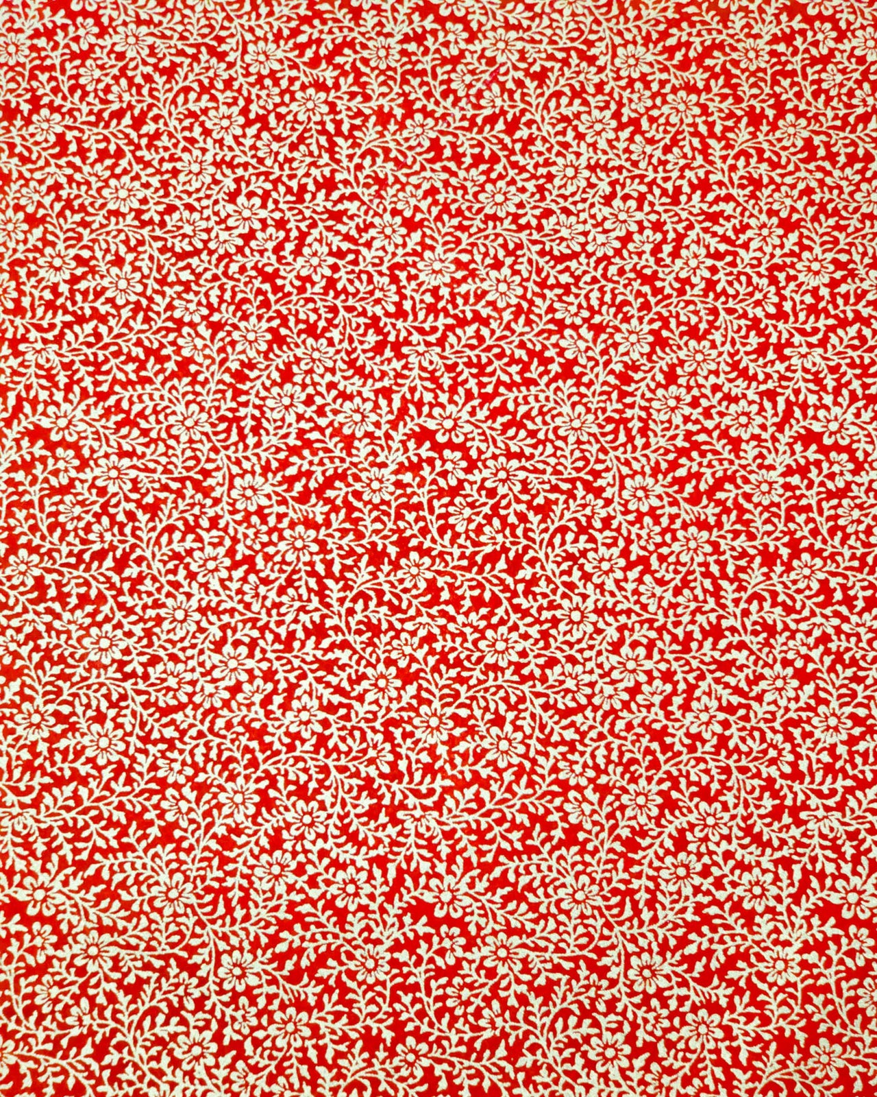Japanese chiyogami paper featuring a metallic gold floral motif on a bright red background.