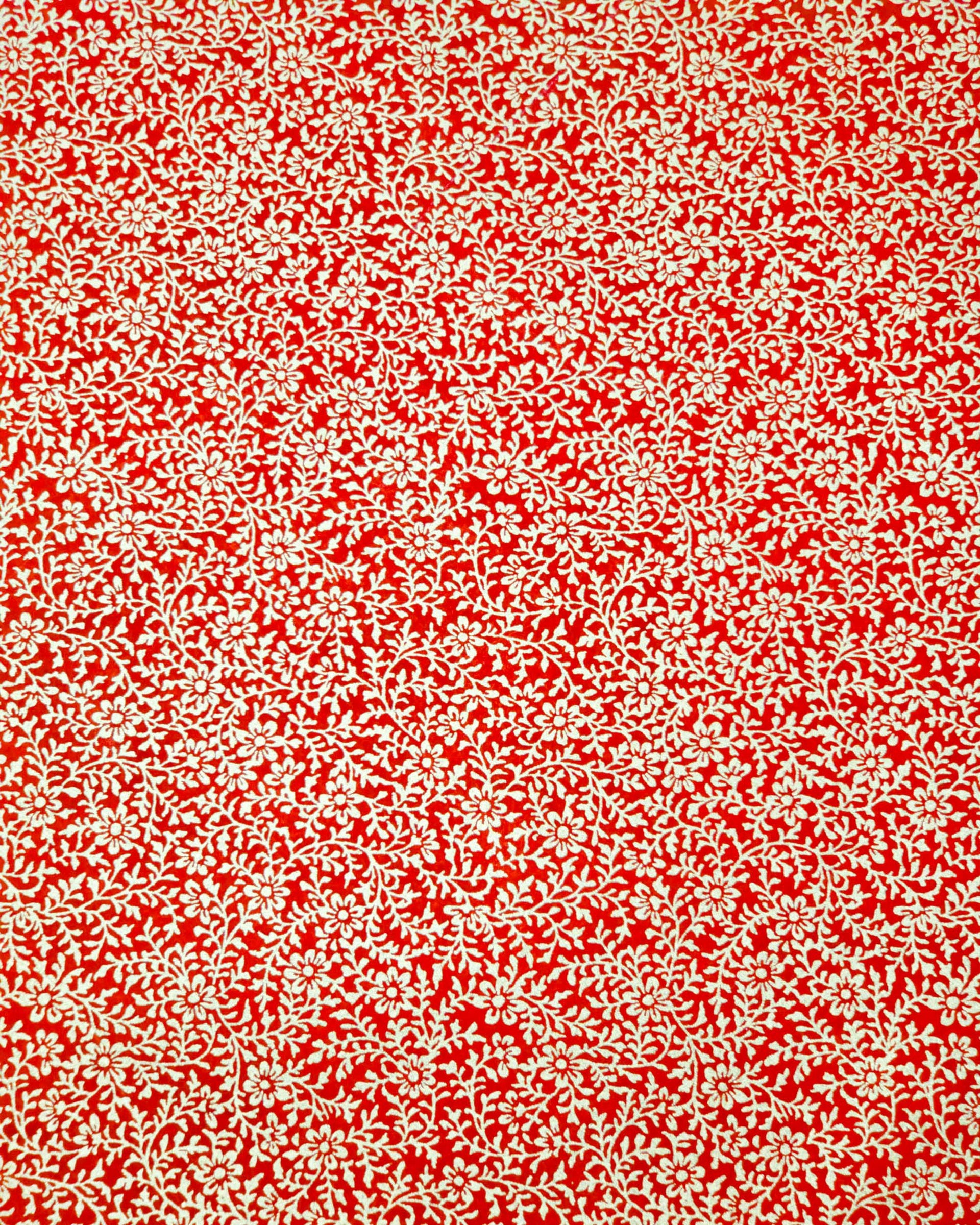 Japanese chiyogami paper featuring a metallic gold floral motif on a bright red background.