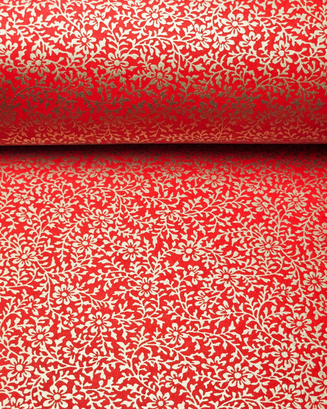Japanese chiyogami paper featuring a metallic gold floral motif on a bright red background.
