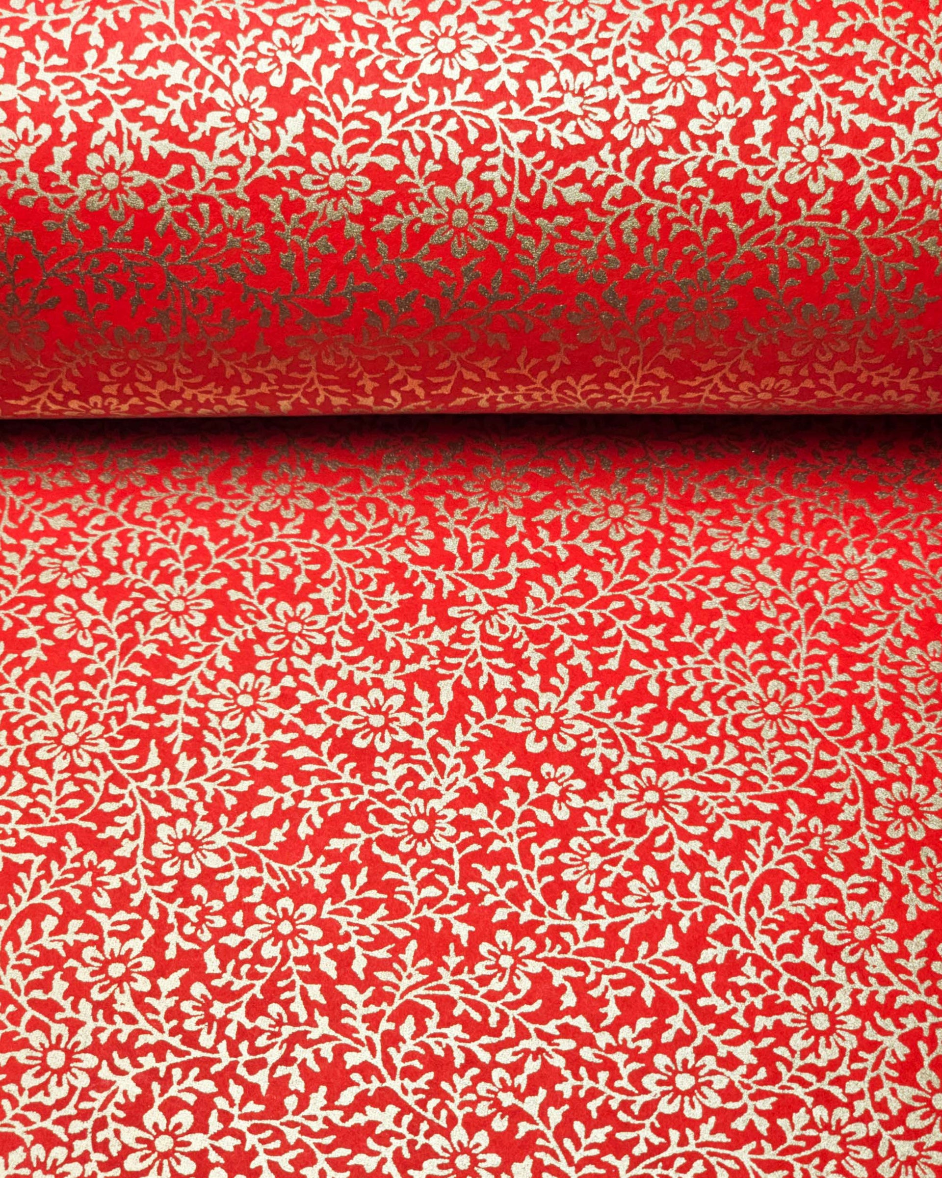 Japanese chiyogami paper featuring a metallic gold floral motif on a bright red background.