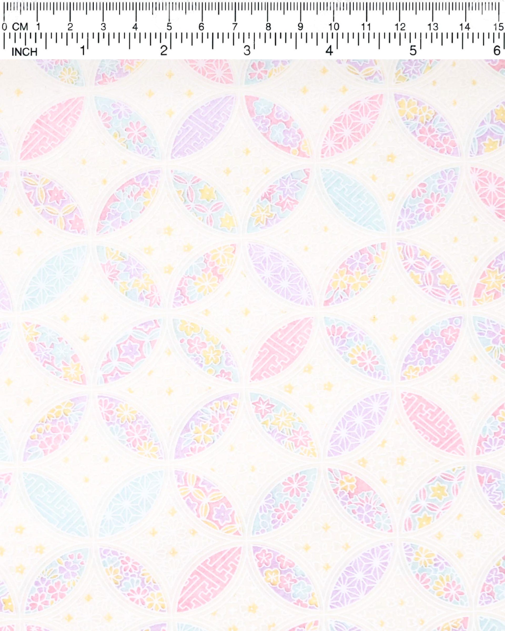 Japanese chiyogami paper featuring a light pastel-colored shippo design filled with floral and geometric designs in shades of pink, purple, blue, and yellow on a white background.