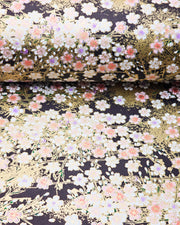 Japanese chiyogami paper featuring pink cherry blossoms and white cherry blossoms with purple and pink centers on a black background with metallic gold details.