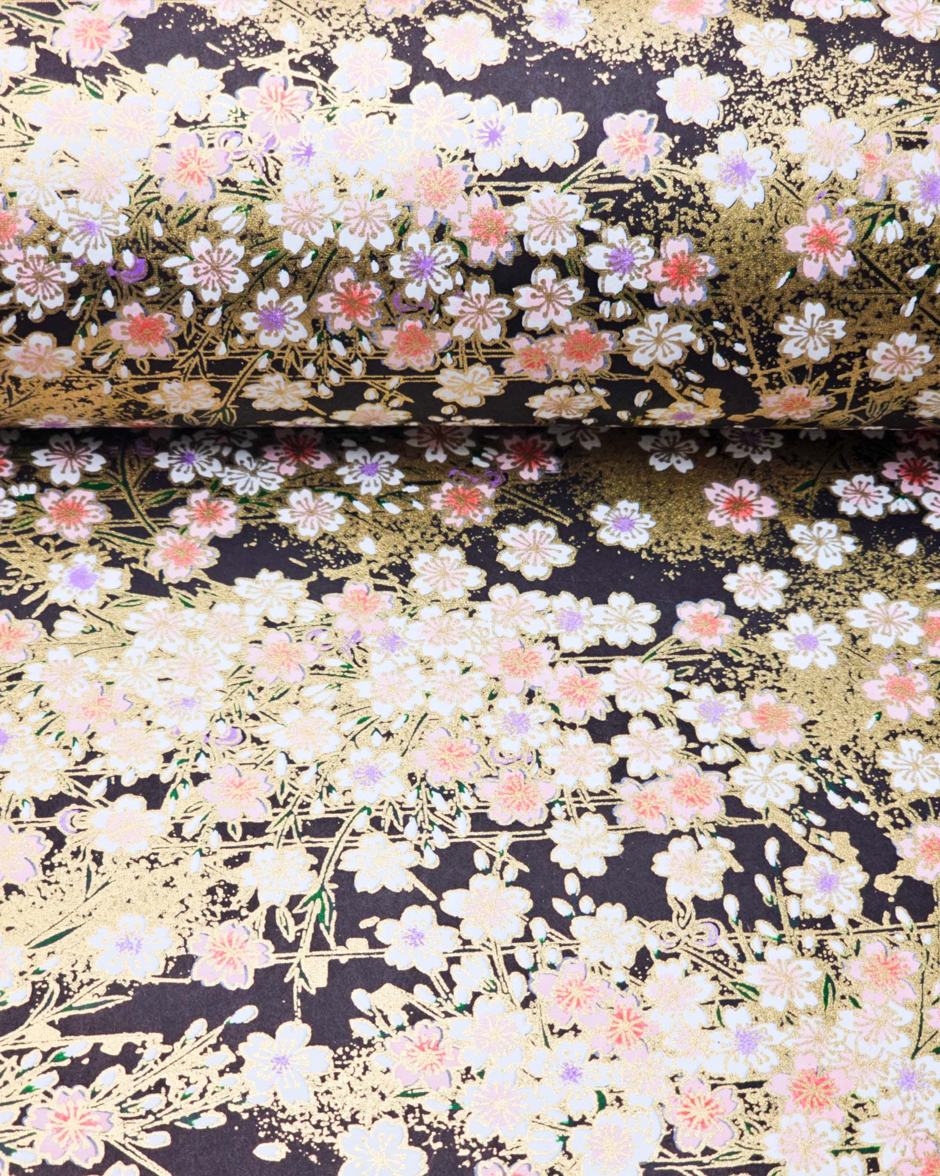 Japanese chiyogami paper featuring pink cherry blossoms and white cherry blossoms with purple and pink centers on a black background with metallic gold details.