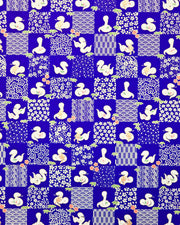 Japanese chiyogami paper featuring white snakes and white assorted traditional Japanese designs in an ichimatsu (checker) design on a blue background with metallic gold details. Small red flowers and green leaves accent the design.