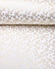 Japanese chiyogami paper featuring metallic gold snowflakes of various sizes on a white background.