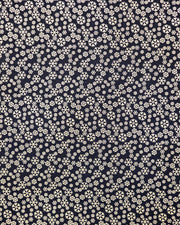 Japanese chiyogami paper featuring metallic gold snowflakes of various sizes on a black background.