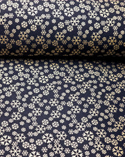 Japanese chiyogami paper featuring metallic gold snowflakes of various sizes on a black background.
