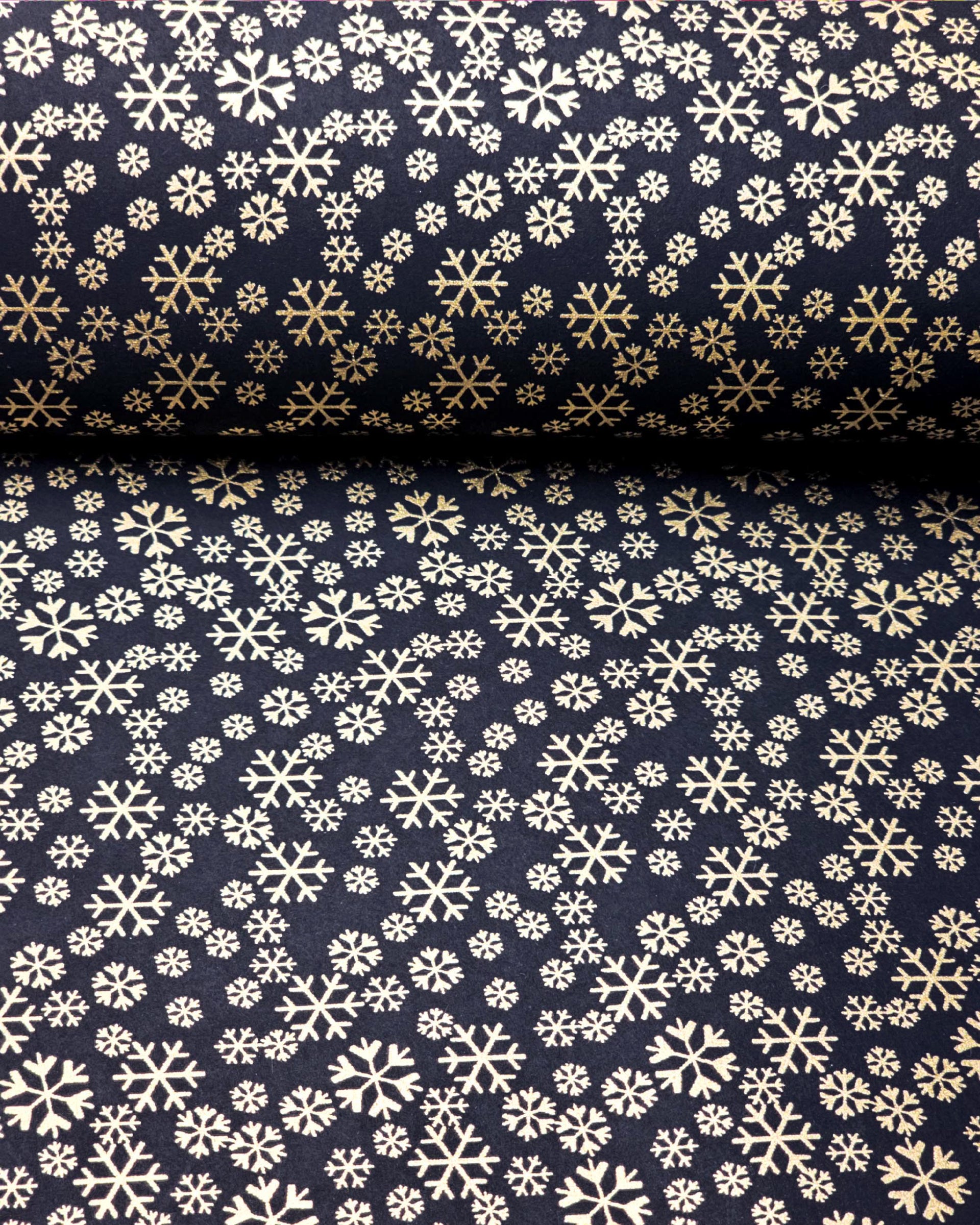Japanese chiyogami paper featuring metallic gold snowflakes of various sizes on a black background.