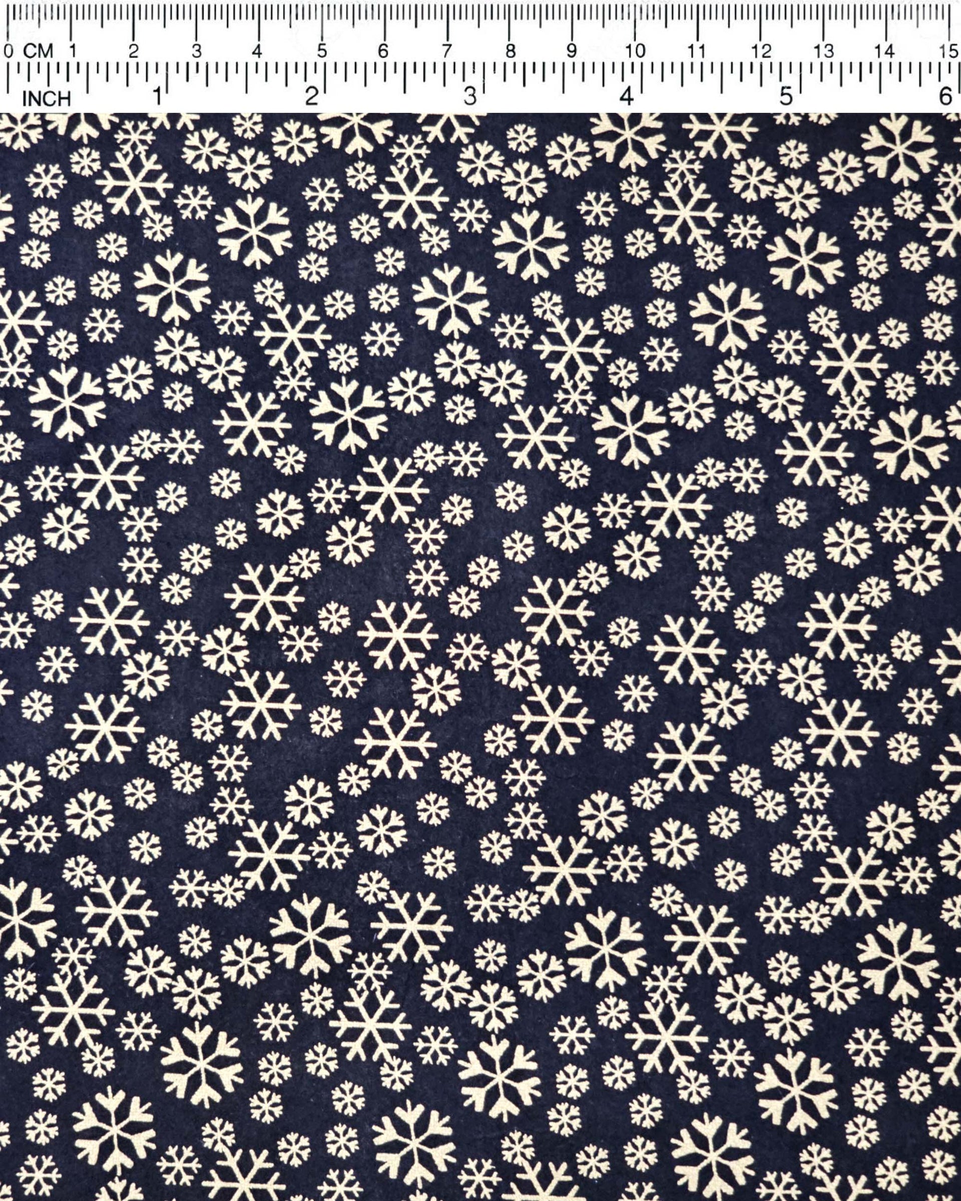 Japanese chiyogami paper featuring metallic gold snowflakes of various sizes on a black background.