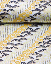 Japanese chiyogami paper featuring orange plum blossoms, black pine, and green bamboo on a metallic silver background with metallic gold details.