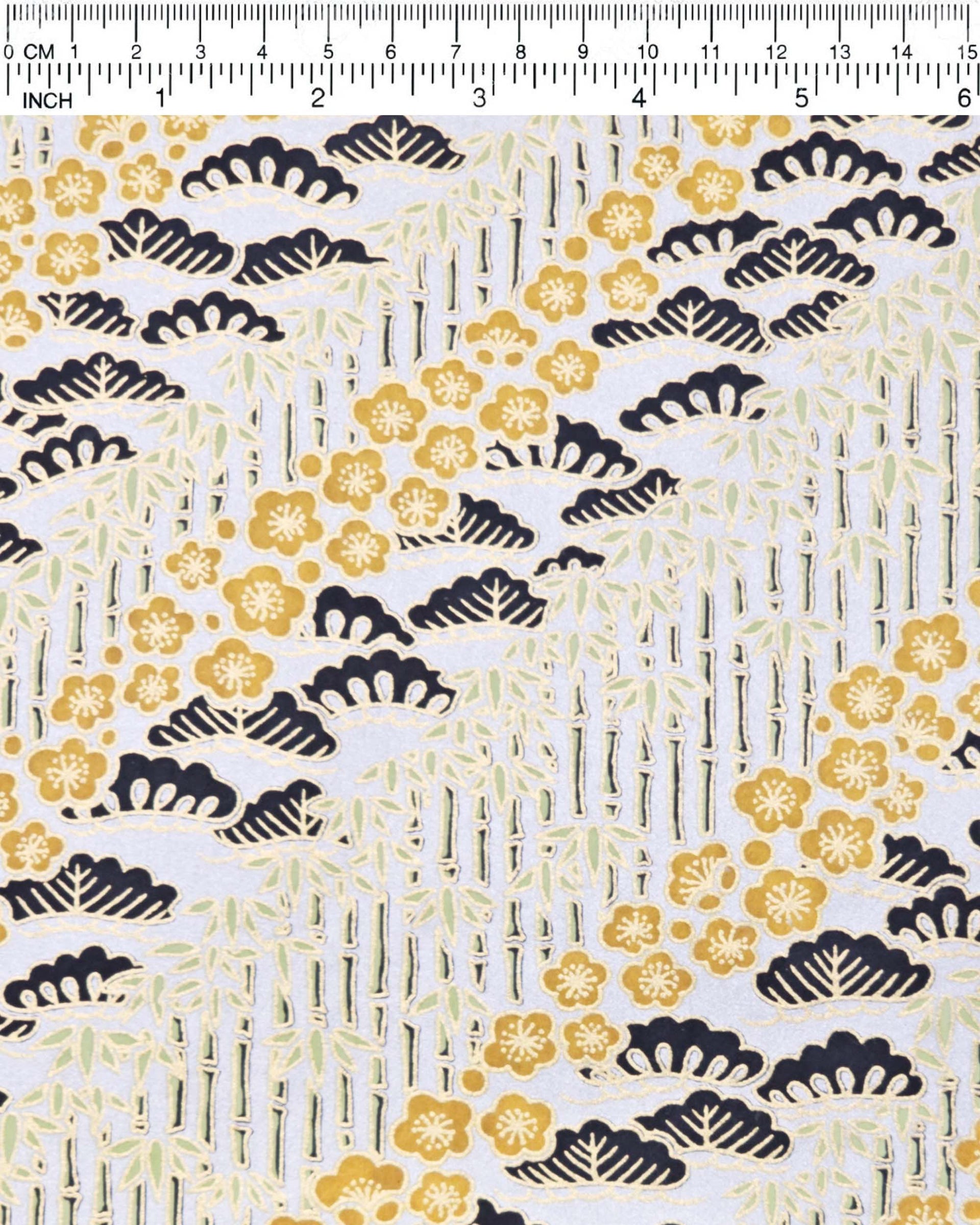 Japanese chiyogami paper featuring orange plum blossoms, black pine, and green bamboo on a metallic silver background with metallic gold details.