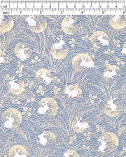 Japanese chiyogami paper featuring white rabbits with gold moons on a blue gray background with metallic gold details.