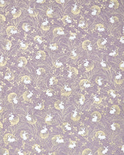 Japanese chiyogami paper featuring white rabbits with gold moons on a purple background with metallic gold details.