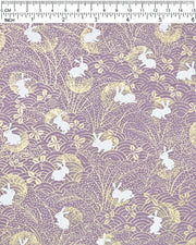 Japanese chiyogami paper featuring white rabbits with gold moons on a purple background with metallic gold details.